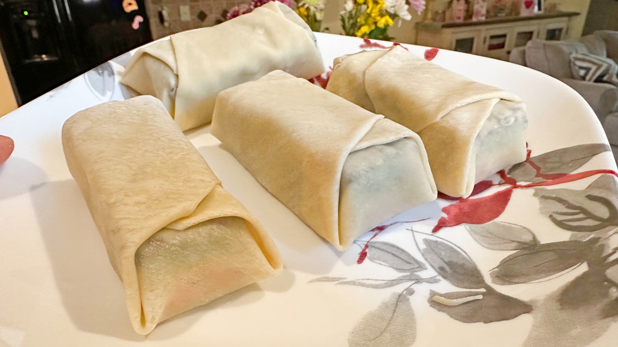 A plate of rainbow cookie egg rolls before frying.