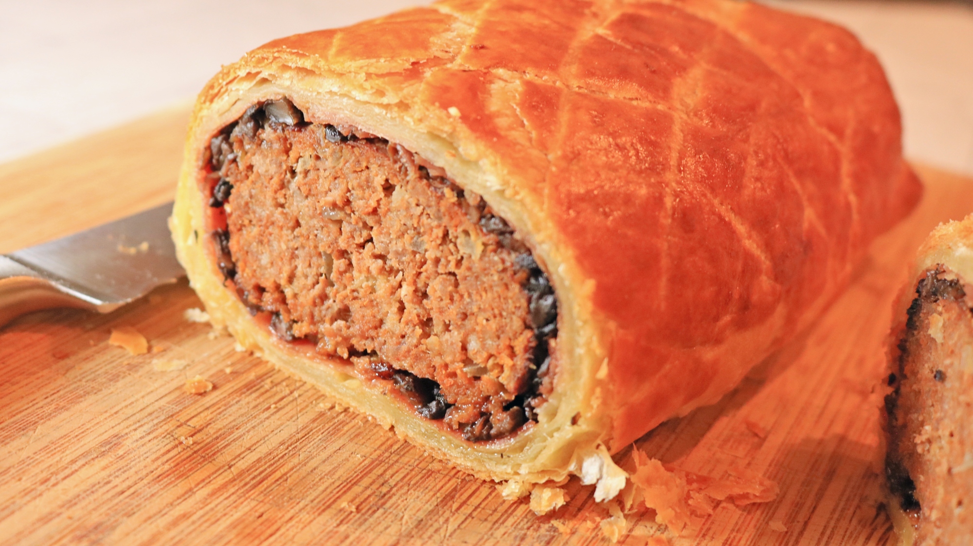 A meatloaf Wellington sliced to reveal the center.