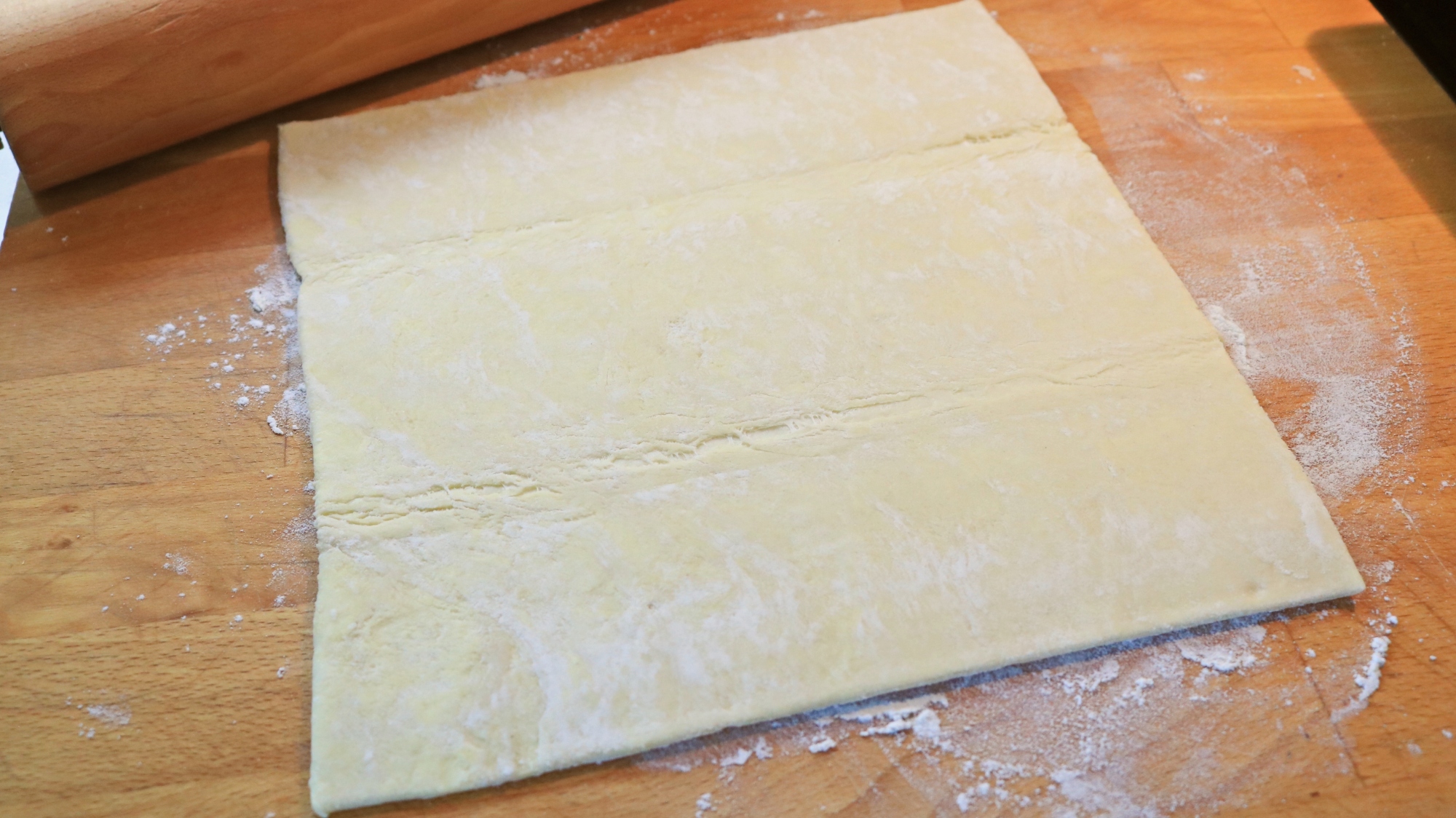 Puff pastry on a cutting board.