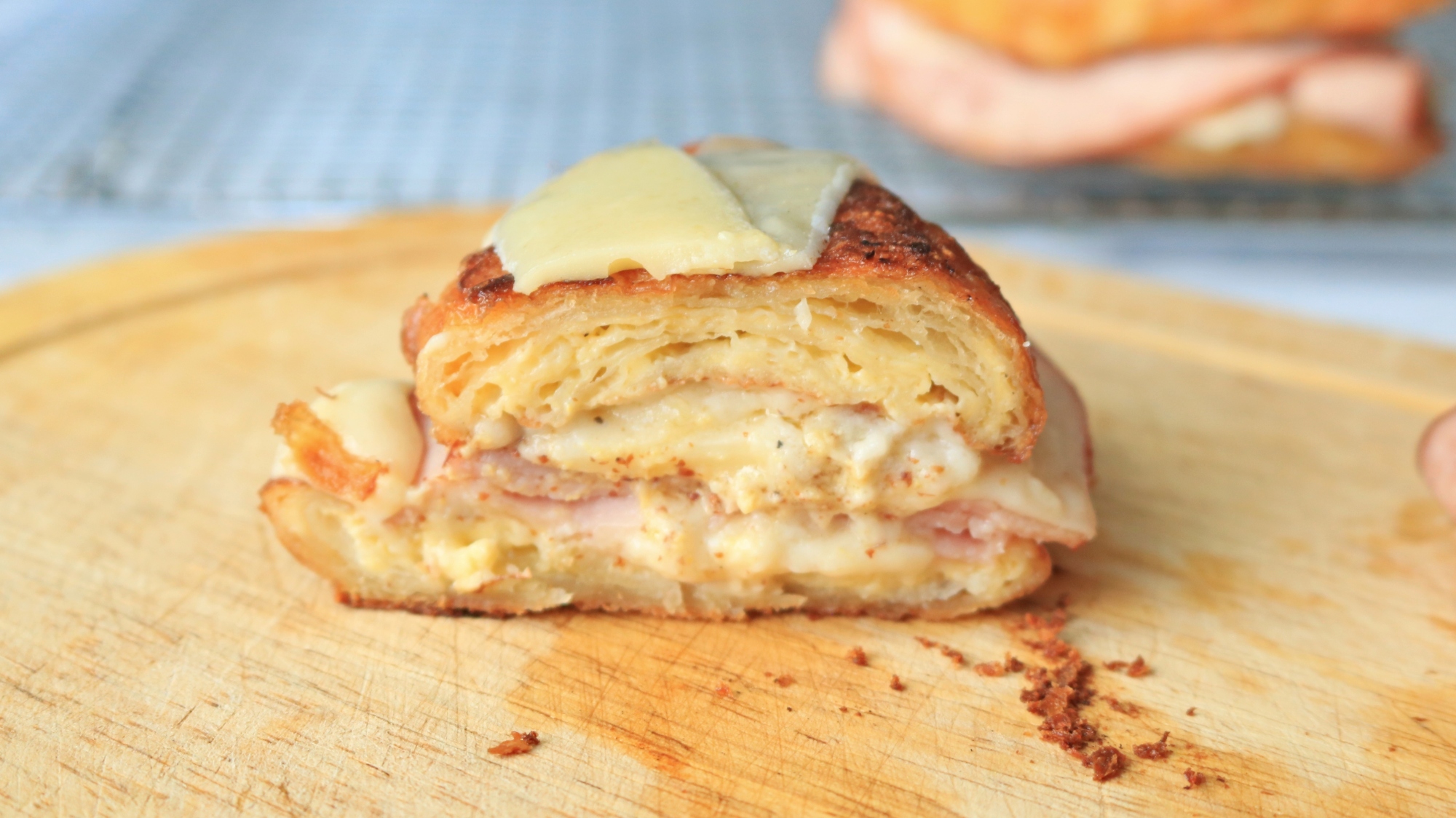 Croissant sandwich cut in half to reveal the layers.